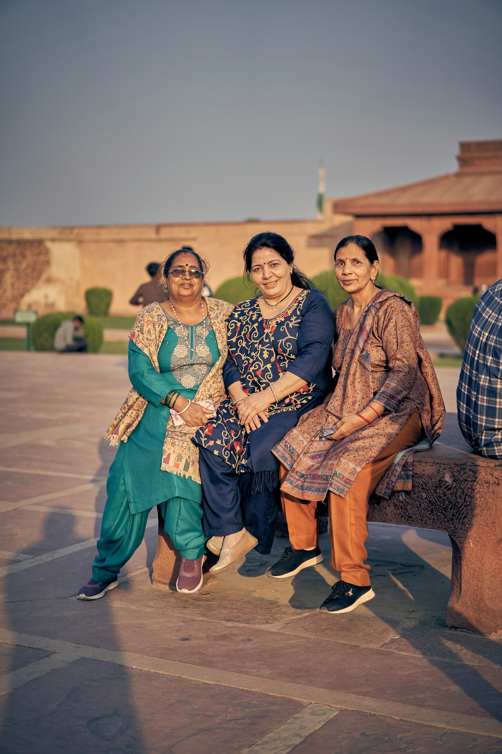 Women in traditional Indian clothing in a courtyard