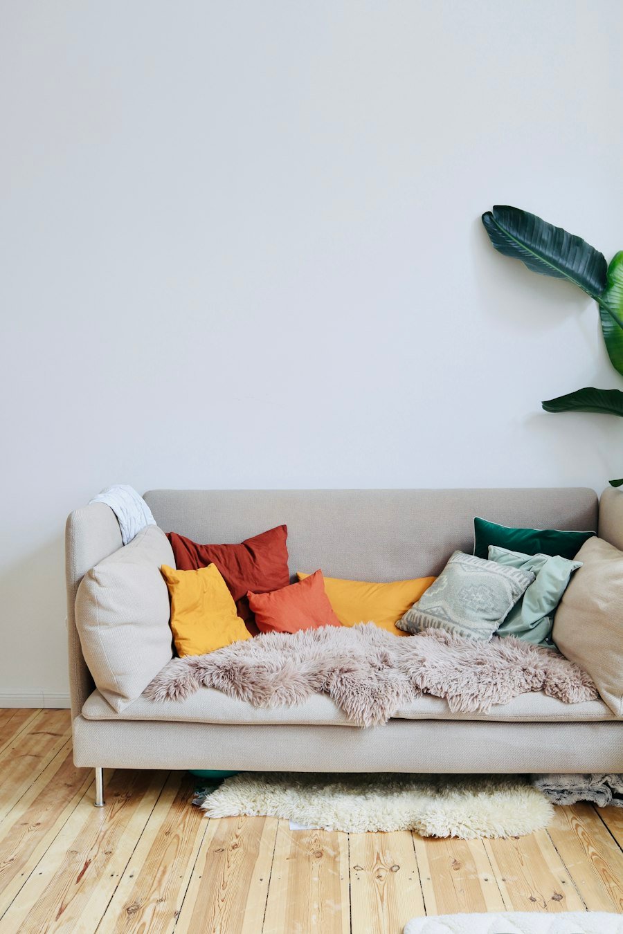Orange cushions on a white sofa