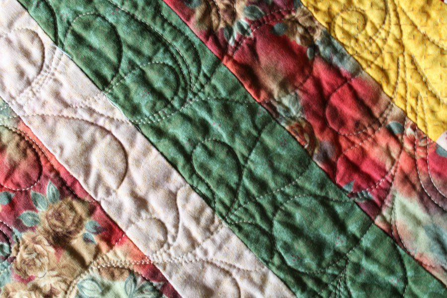 Colourful quilt on a bed