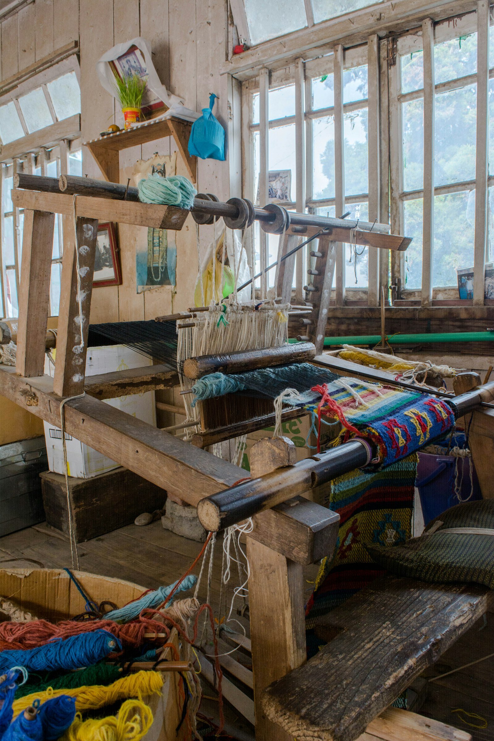 Wooden handloom with colourful woven fabric