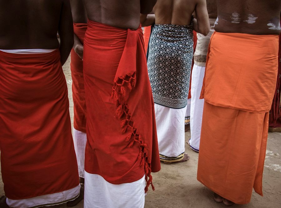 Men in traditional white dhotis
