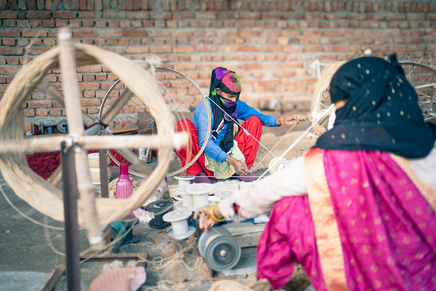Woman spinning yarn at a spinning wheel