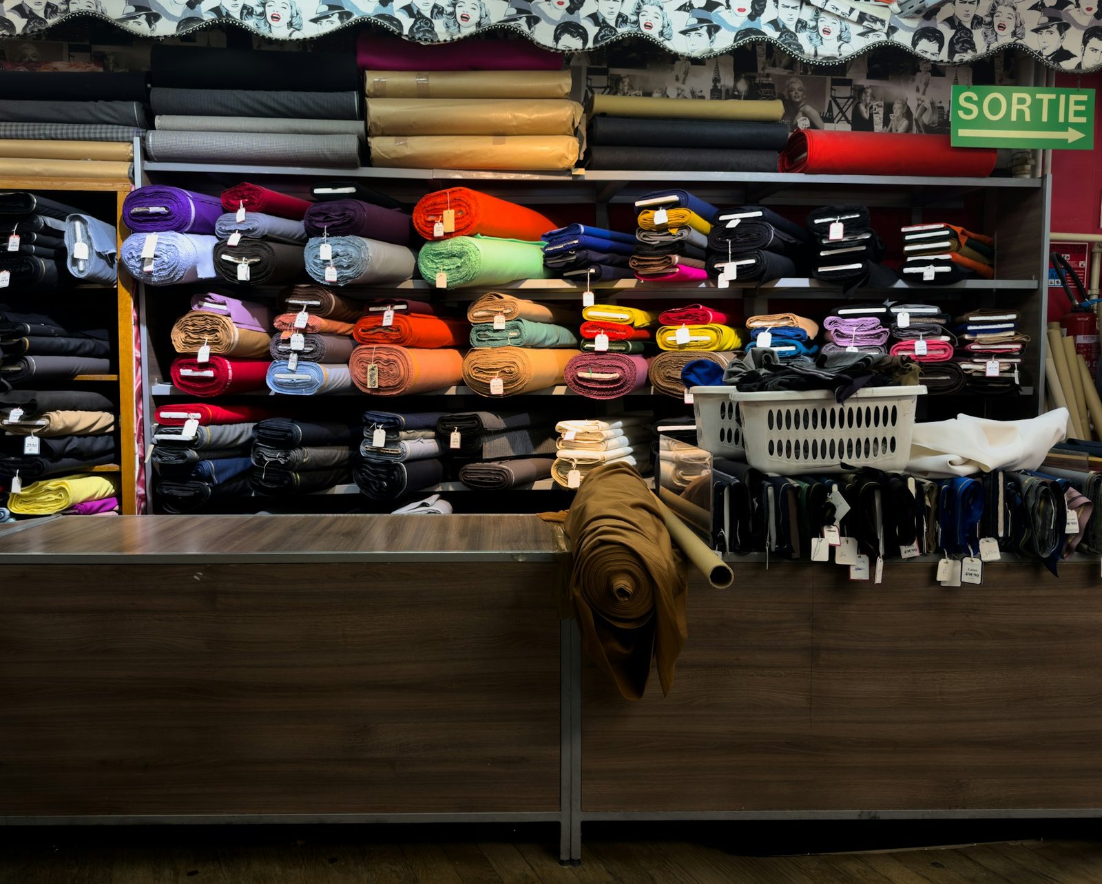 Rolls of colourful fabric on store shelves