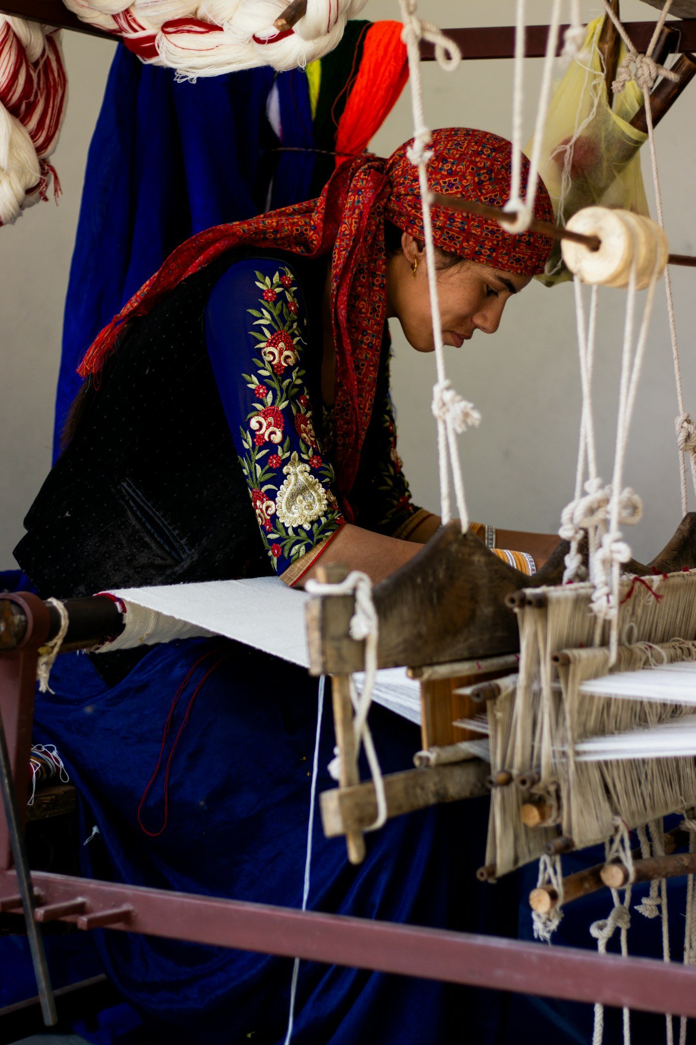 Woman working at a weaving loom