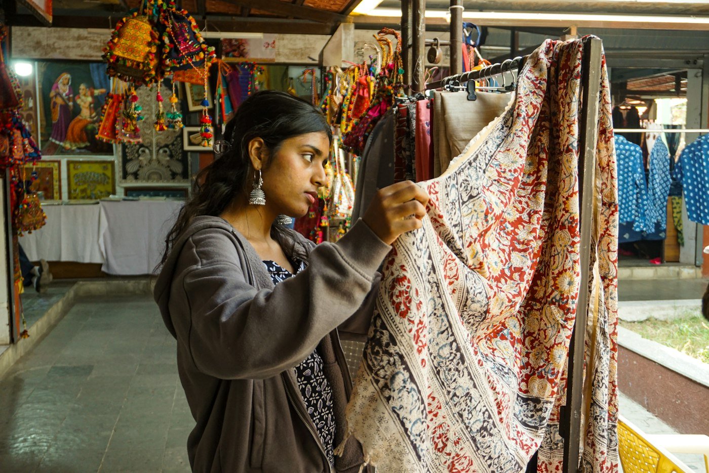 Customer examining fabric at a textile market